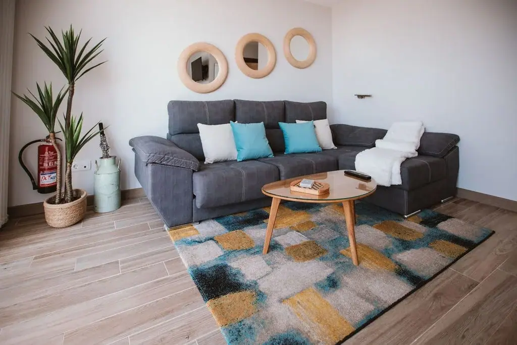 Living room of a Standard apartment with a sofa and turquoise cushions