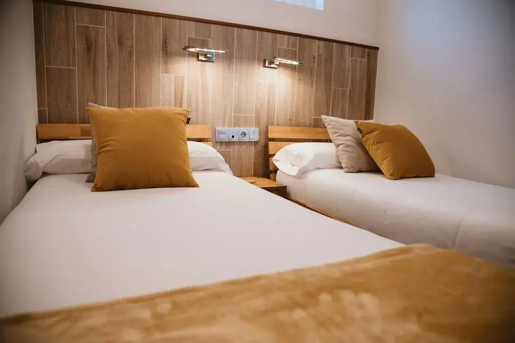 Twin bedroom with wooden headboards in a Standard apartment
