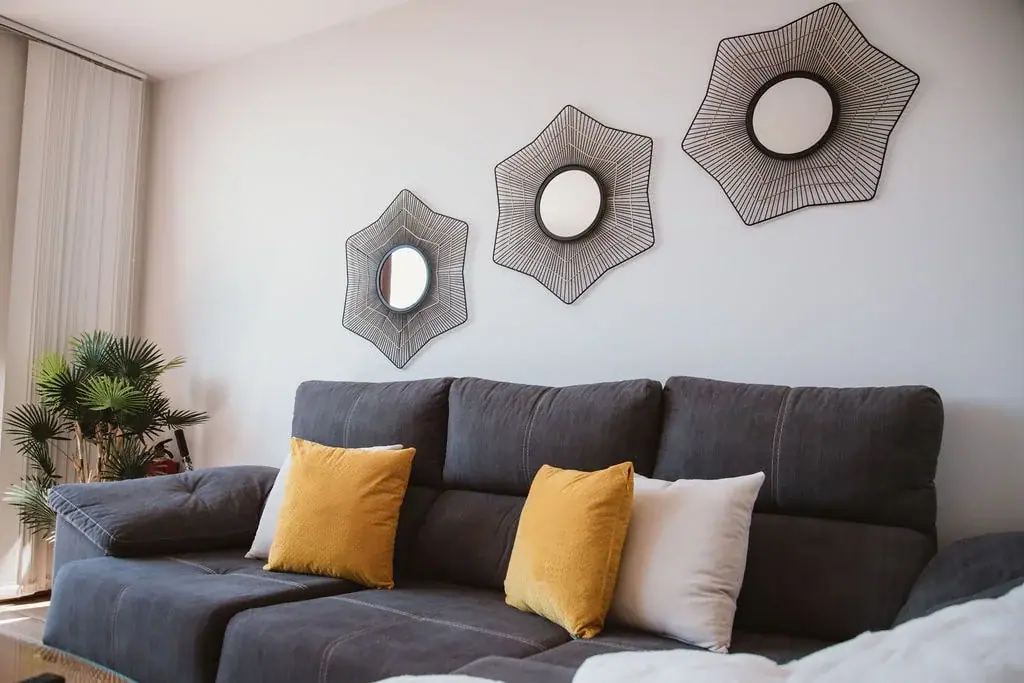 Living room of a Standard apartment with a grey sofa and yellow cushions