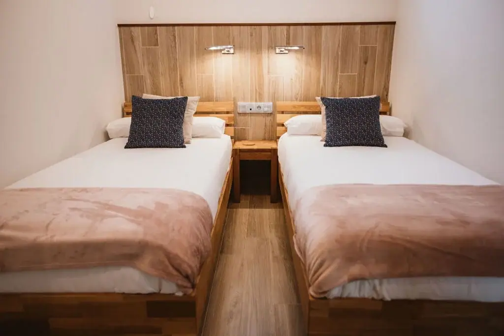 Twin bedroom with wooden headboards in a Standard apartment