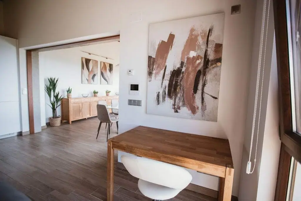 Living room of the Deluxe apartment with a table and a painting