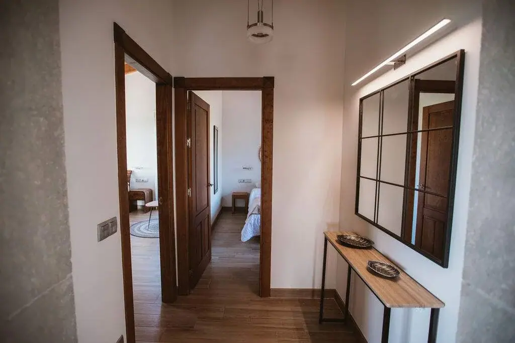Entrance hall of the Deluxe apartment with a mirror and a wooden console