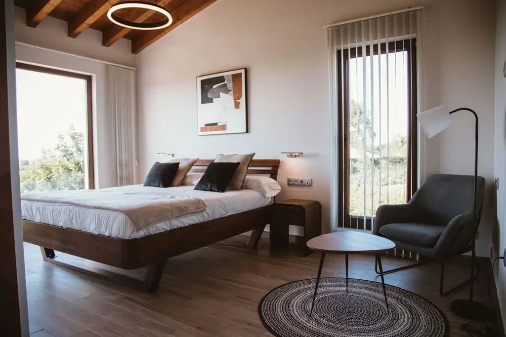 Bedroom of the Deluxe apartment with an armchair by the picture window