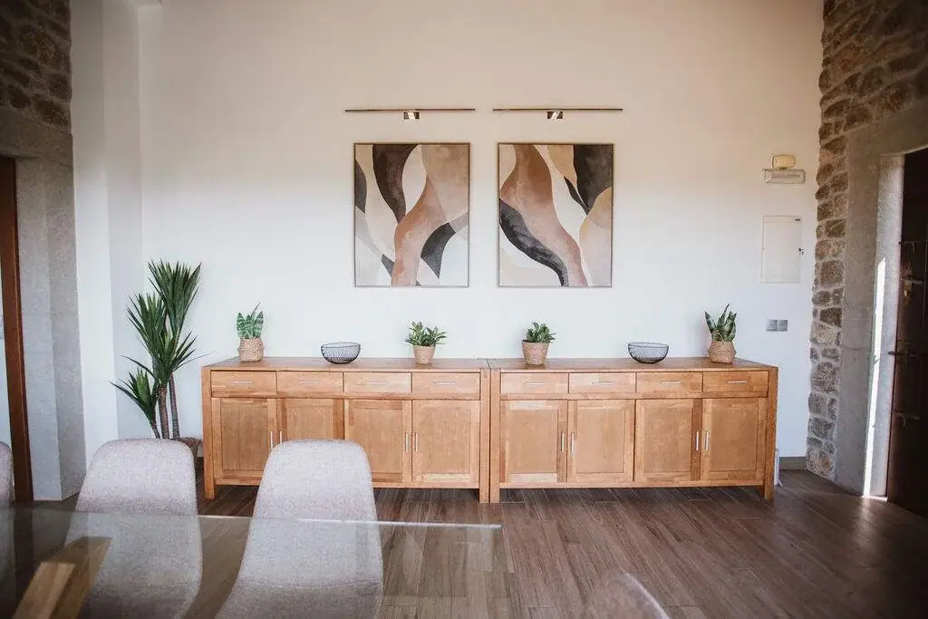 Wooden sideboard and paintings in the dining room of the Deluxe apartment
