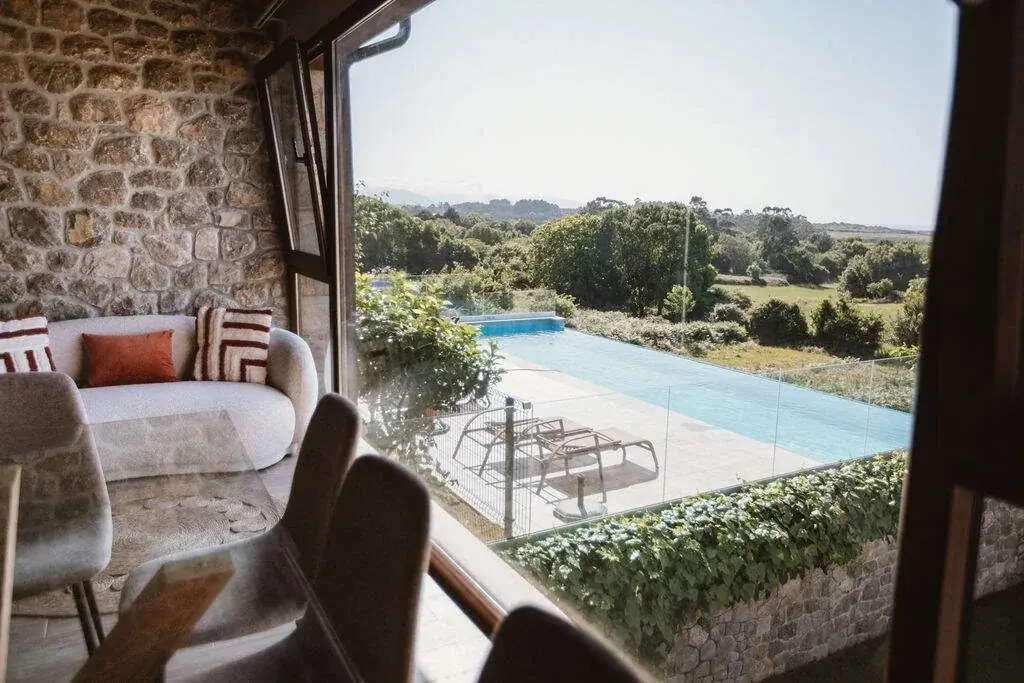 Living room of the Deluxe apartment with views of the pool
