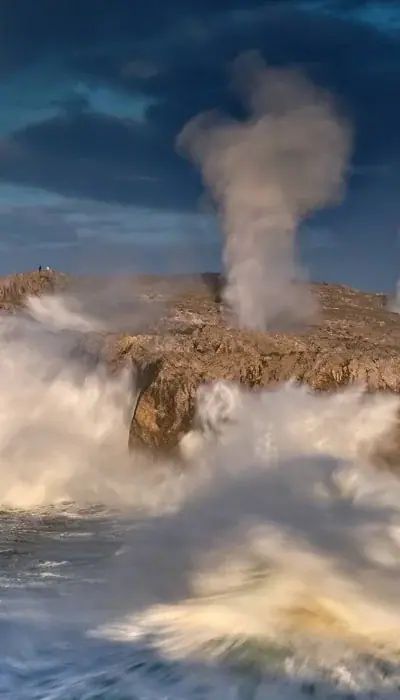 A blowhole's jet over the cliff
