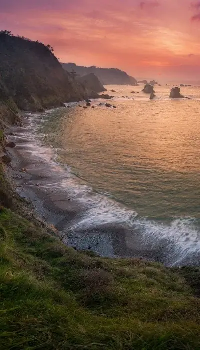 A cove between cliffs at sunset