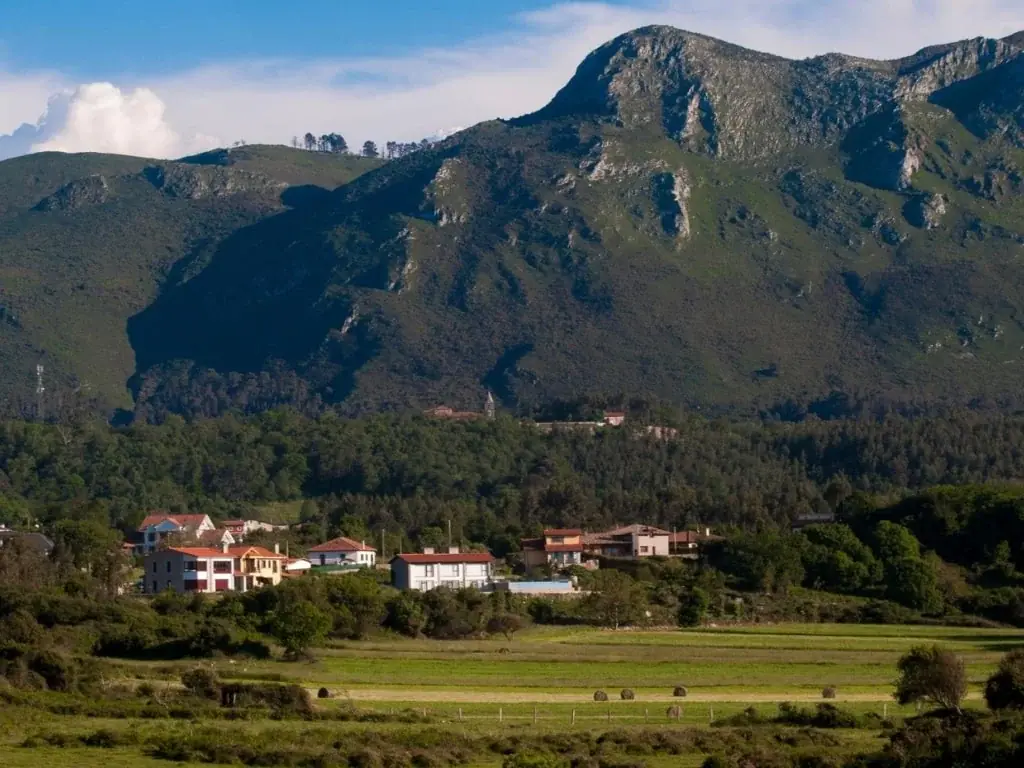 Casas de Pría en el prado, con la sierra del Cuera detrás
