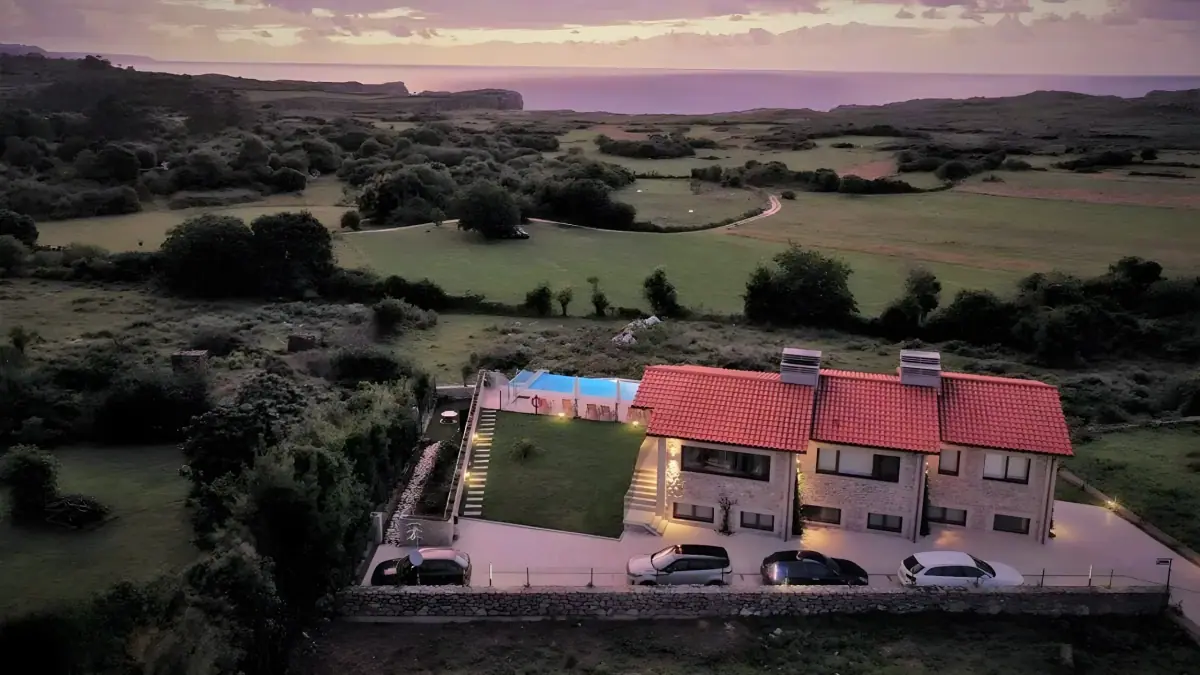 Aerial view of the apartments among the meadows at sunset