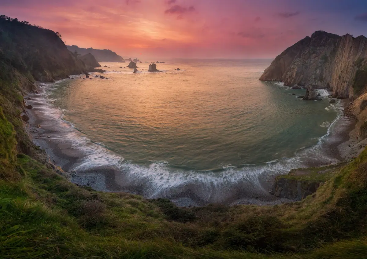 A cove between cliffs at sunset