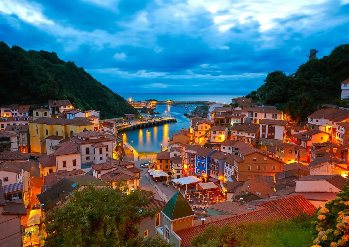 A fishing village lit up at dusk