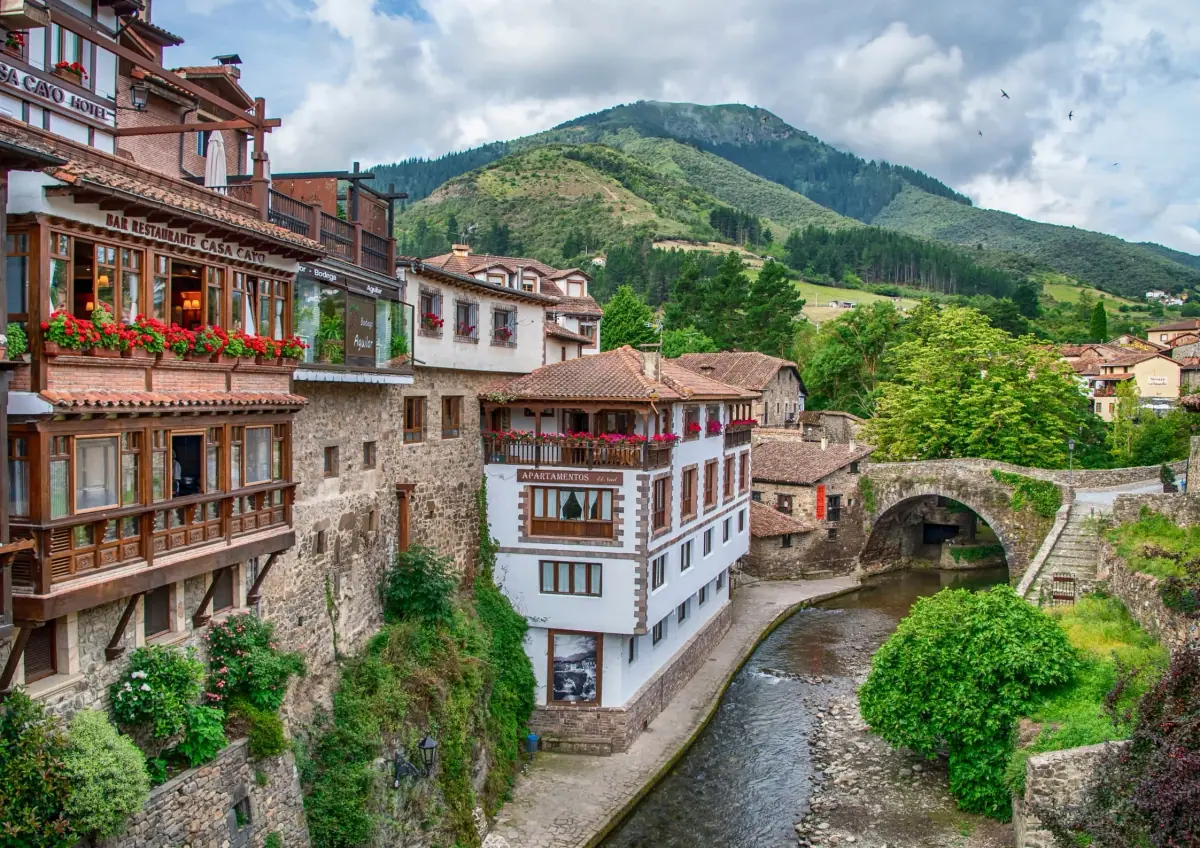 A mountain village with wooden balconies over the river