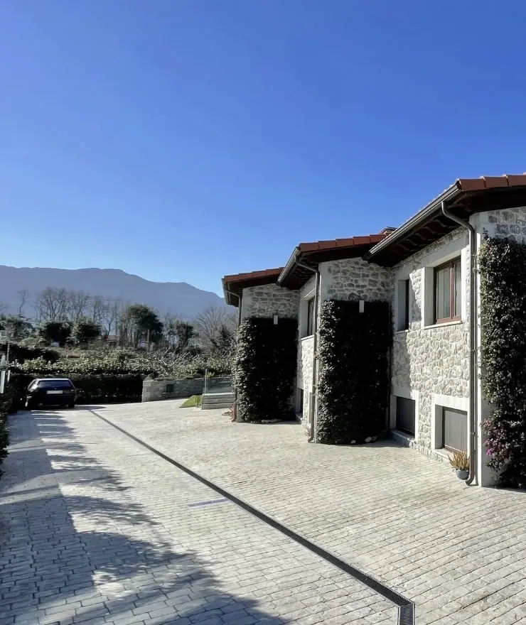 Free parking beside the stone building of the apartments