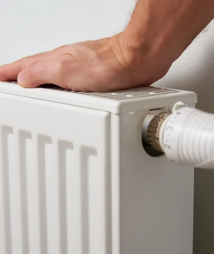 A hand on a heating radiator