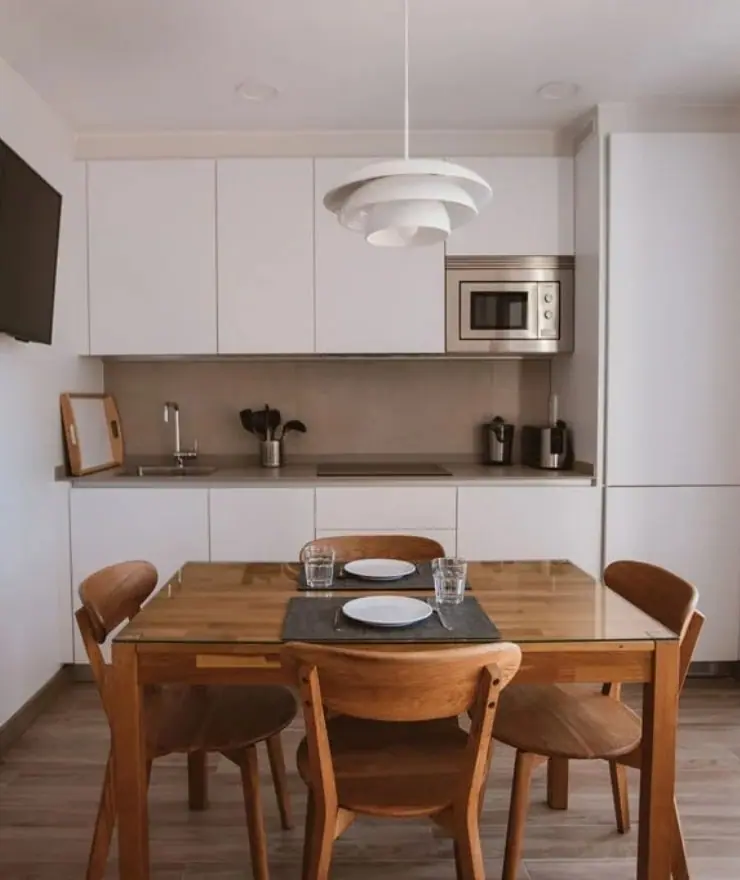 Equipped kitchen of a Standard apartment with a table for four