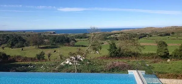 The meadow and the sea from the edge of the pool