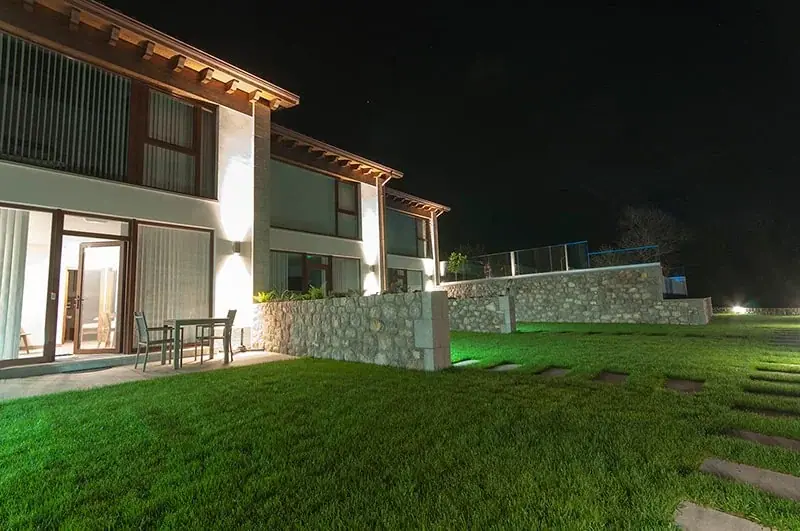 The apartments and the garden lit up at night