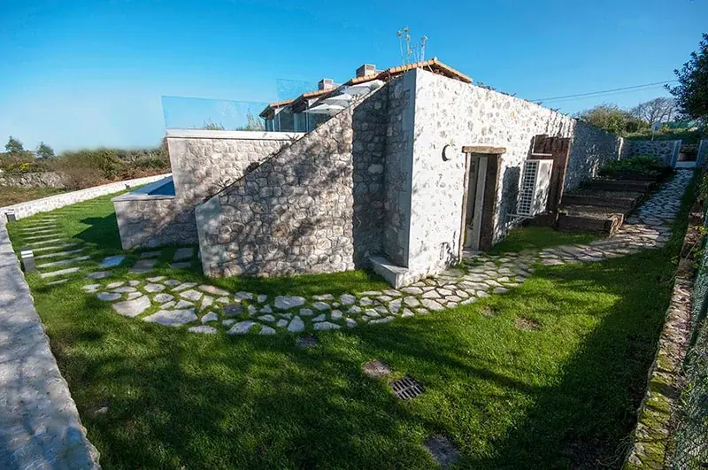 Stone walls of the house and the garden