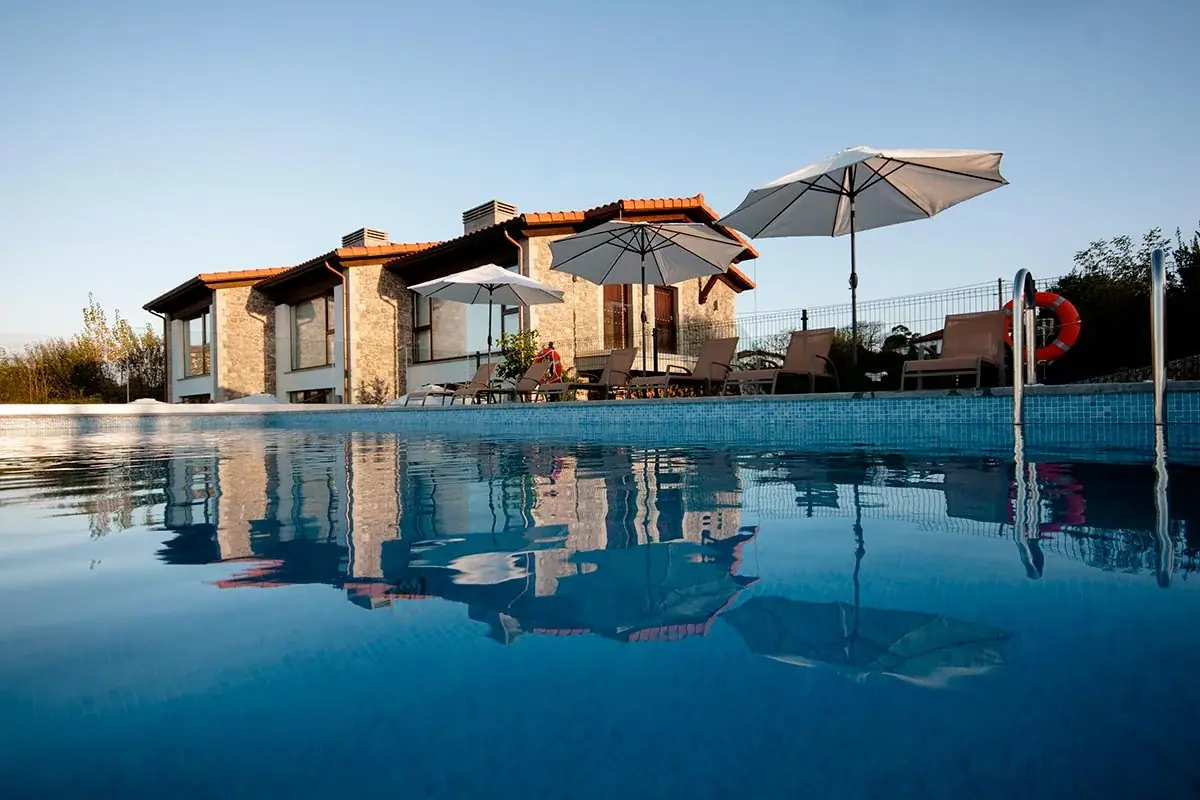 The house and its parasols reflected in the pool