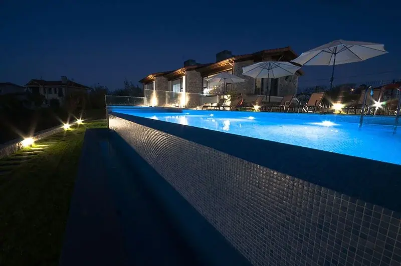 The infinity pool lit up at night