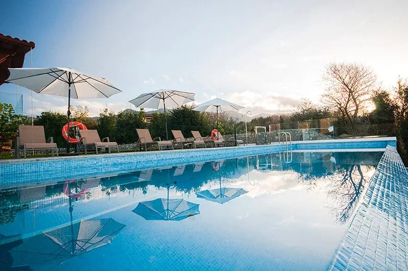 Pool with parasols and sun loungers